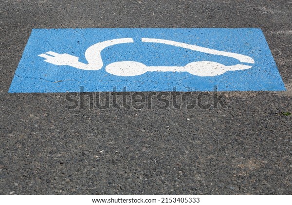 Electric car charging\
symbol on a parking