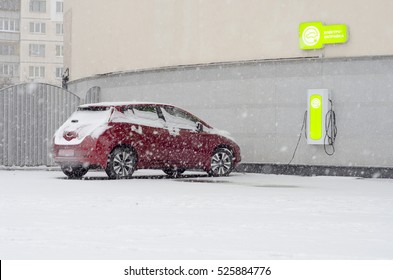 Electric Car At Charging In Winter