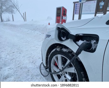 Electric Car Is Charging In Winter. Germany, 2021