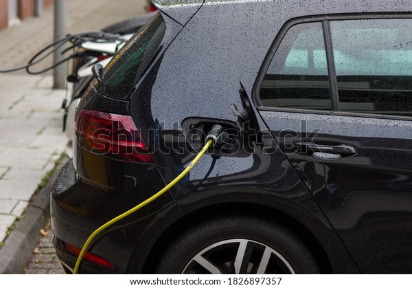 Electric car connected to charge station for\
charging the battery
