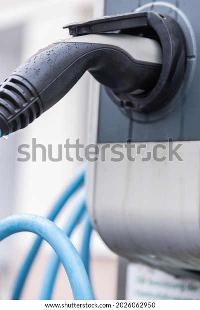 Electric car connected to charging station -\
close-up electric\
vehicles