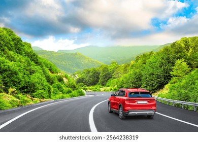 Electric car drive on spring road in beautiful nature landscape. spring colors in green mountain road landscape. summer view on highway in forest. nature trip in summer. Red suv car drive on highway. - Powered by Shutterstock