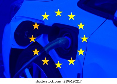 An electric car and European Union EU flag - Shutterstock ID 2196120217