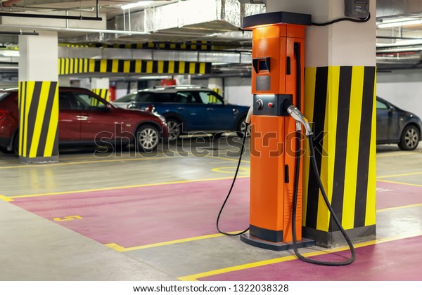 Electric car fast charging station at indoor\
underground parking. Power supply point network for hybrid electric\
car charging battery. Eco green\
energy
