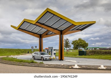 Electric car filling at electricity charge station in the fast expanding car charging network in the Netherlands