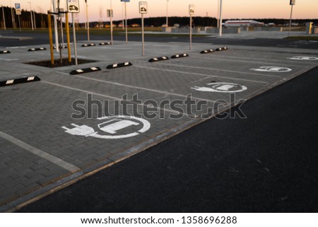Electric car free charge - Empty parking lots during Golden Hour sunset at a popular typical Shopping centre