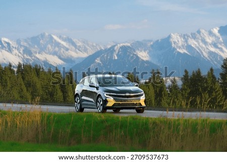 Electric car glides down empty scenic road
