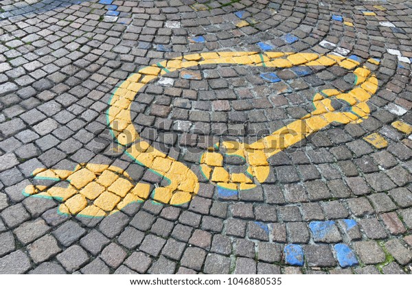 Electric car logo\
painted on soil in reserved parking zone near docking station Turin\
Italy March 14 2018