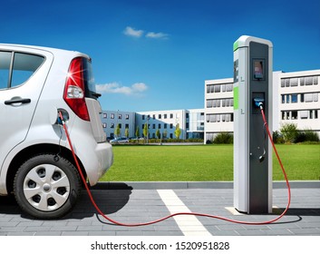 Electric car on charging spot in front of architecture office buildings - Car sharing commuter charging station - Shutterstock ID 1520951828