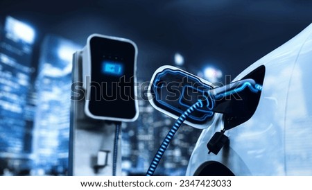 Electric car plugged in with charging station to recharge battery with electricity by EV charger cable in dark blue futuristic cyberpunk city night . Innovative ev car and energy sustainability.Peruse