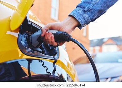 Electric Car Plugged In Outside House On Street