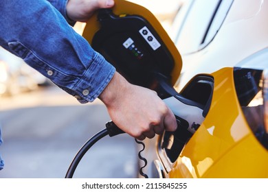 Electric Car Plugged In Outside House On Street