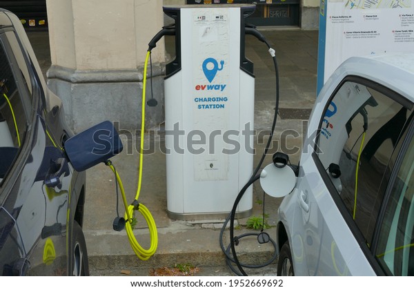 Electric car plugged to recharge station Turin Italy\
April 9 2021