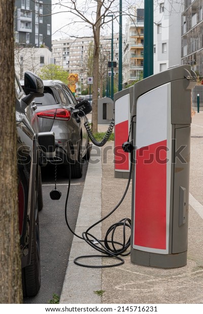 Electric car plugged\
to an electric\
terminal