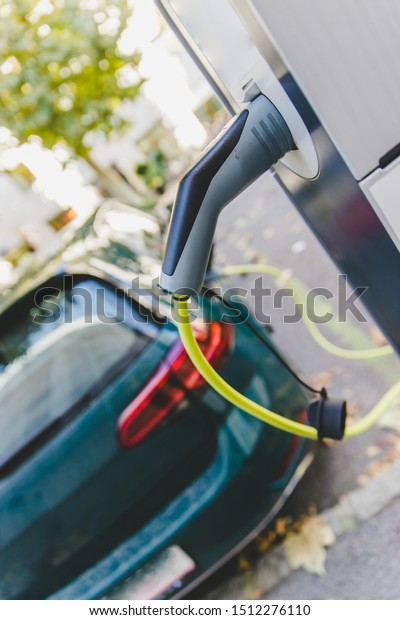 Electric car recharging with charge cable and plug\
leading to charge\
point