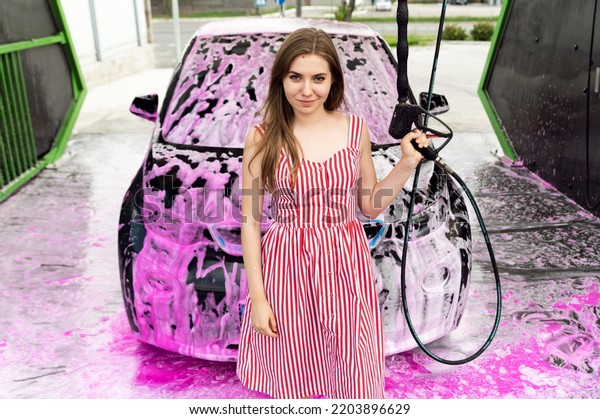 electric car
at a self-service  wash. pink car wash. clean. electric car
cleaning. average washing equipment.
service