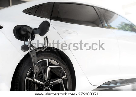 Electric car using V2L adapter to supply electricity through power strip from charging port clean energy and mobile power solution
