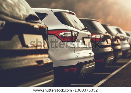 electric cars SUVs parked in row on dealership parking