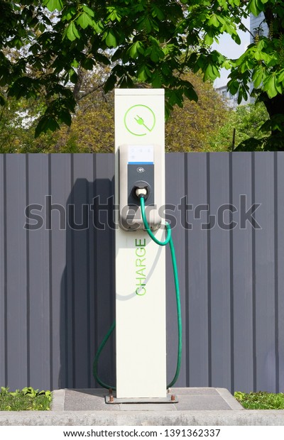 Electric charging\
station. Eco friendly transport concept. Sign on front of charging\
station. Vertical\
view.