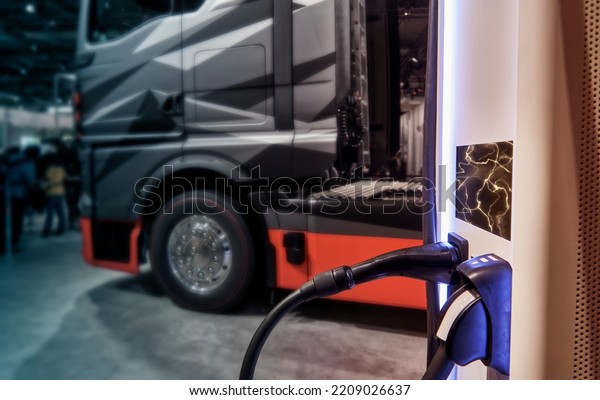 Electric charging station for\
trucks with electric and hydroelectric motor, blurred truck in\
background