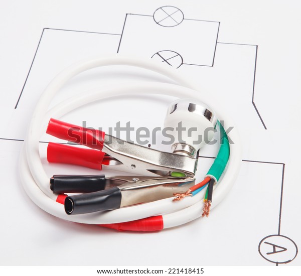 Electric clamps and electric cable on a background of\
the electric scheme 