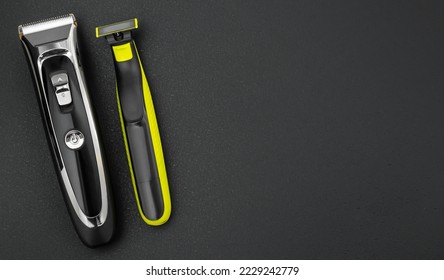 Electric clipper and electric shaver on black. Top view. Space for text. - Shutterstock ID 2229242779