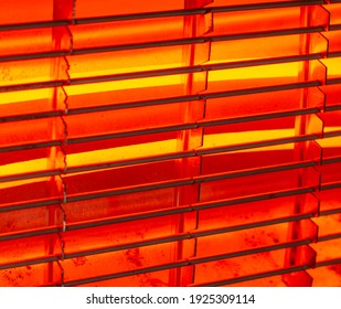 Electric Coil Heater Glowing Orange In The Dark Room. Close Up. Detail.
