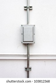 Electric Control Box On The White Wall Of Factory.