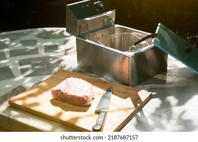 Electric Deep Fryer With Ingredients For Making Tonkatsu Stuffed With Cheese.