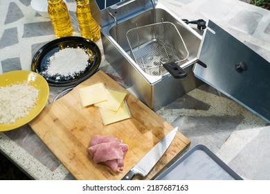 Electric Deep Fryer With Ingredients For Making Tonkatsu Stuffed With Cheese.