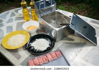 Electric Deep Fryer With Ingredients For Making Tonkatsu Stuffed With Cheese.