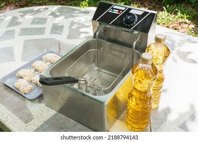 Electric Deep Fryer With Ingredients For Making Tonkatsu Stuffed With Cheese.