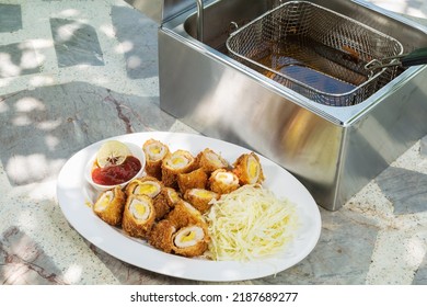 Electric Deep Fryer With Pork Tonkatsu Stuffed With Cheese.