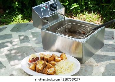 Electric Deep Fryer With Pork Tonkatsu Stuffed With Cheese.