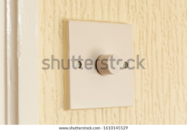 Electric dimmer light switch\
on wall