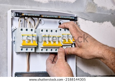 Electric distribution board consumer unit with fuse box or circuit breaker, electrical work to install new panel.