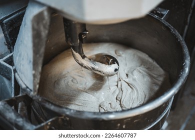 Electric dough mixer machine at the kitchen of bakery. It is mixing sourdough. - Powered by Shutterstock