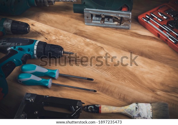 electric\
drill and architectural tools on wooden\
table