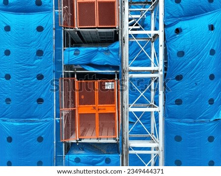 Electric elevator in construction site.