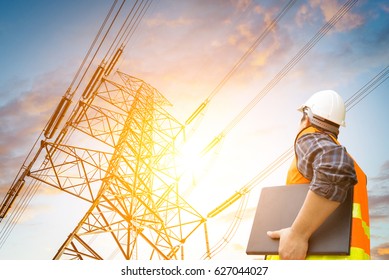 electric engineer check the high voltage pole - Shutterstock ID 627044027
