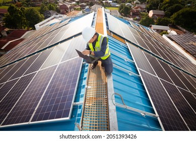 Electric Engineer Working White Safety On Height Building, Installing Solar Panels On The Rooftop Working Using Notebook Computer, Inspecting, Measuring, Collecting Data For Repairing