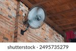 Electric Fan in Brick Wall