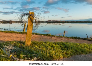 Electric Fence Wire Rolled Up On A Fence Post, As The Floodway Is In Use.