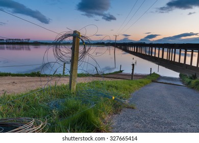 Electric Fence Wire Rolled Up On A Fence Post, As The Floodway Is In Use.