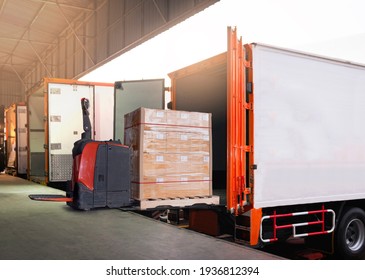 Electric Forklift Loading Shipment Boxes into Cargo Container. Cargo Trailer Truck Parked Loading at Dock Warehouse. Delivery Service. Shipping Warehouse Logistics. Freight Truck Transportation.	