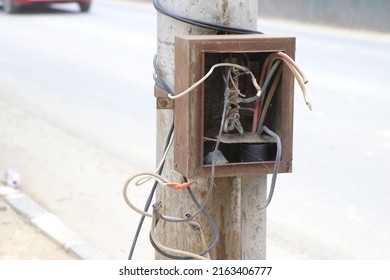 Electric Fuse Box With Broken Wires Or Abandoned Switch Box On A Streetlight