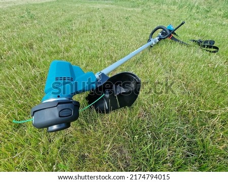 Electric grass trimmer professional gardening tool on lawn grass