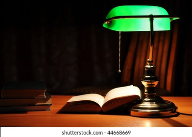 Electric Green Table Lamp And Opened Book