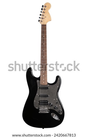 An electric guitar in black with a detailed pickguard isolated on white.