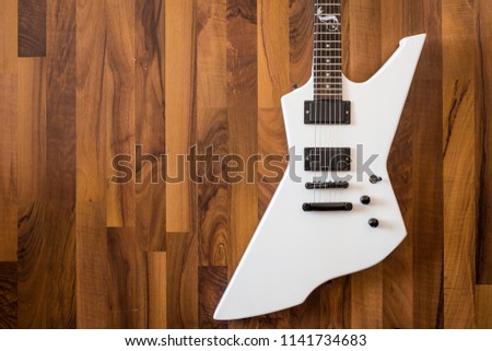 Electric guitar on brown wood background